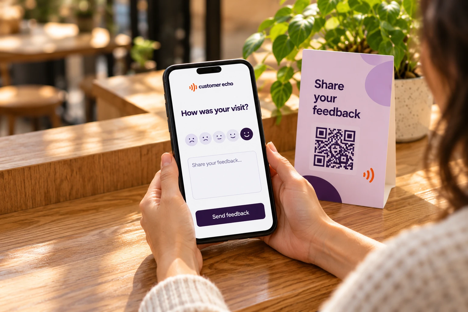 A customer sharing feedback on a phone beside a lavender QR stand